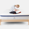 woman sitting on helix mattress on helix natural wood bed frame