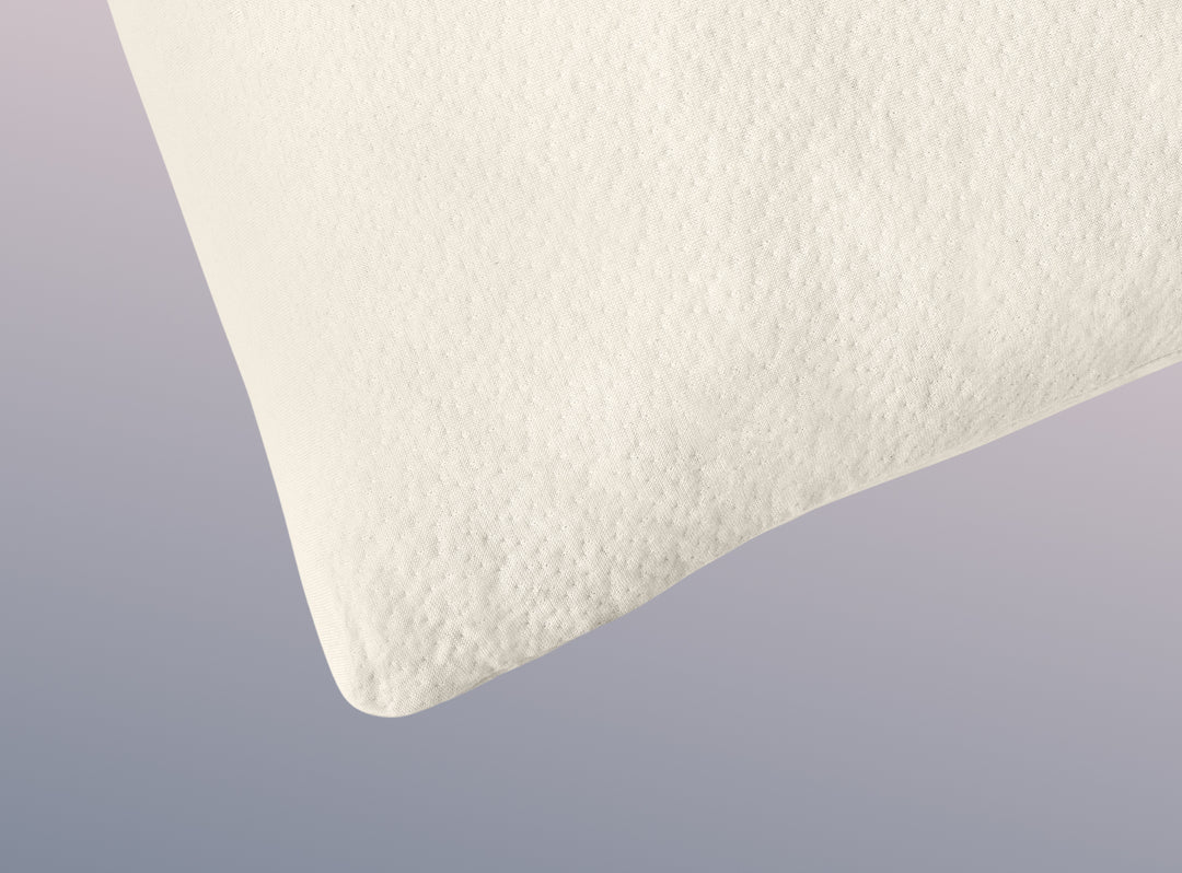 A closeup image of the Organic Pillow on a blue background