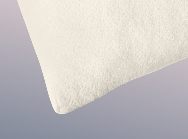 A closeup image of the Organic Pillow on a blue background