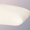 A closeup image of the Organic Pillow on a blue background