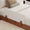 A closeup image of the Bryant Toddler Floor Bed showing its guardrails, which are sold separately 