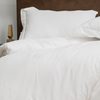 A closeup of the Helix Duvet Cover Set on a bed in a bedroom scene