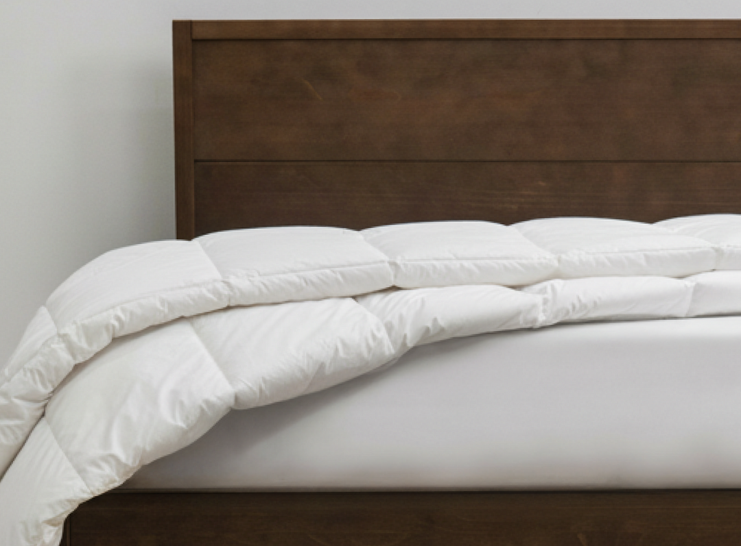 A closeup of the Helix Duvet Insert laid across a mattress on a bedroom scene 