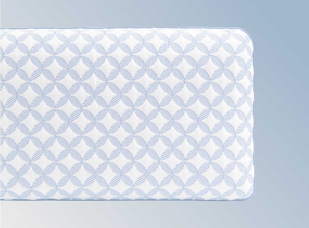 An image of the GlacioTex Cooling Pillow on a light blue gradient background