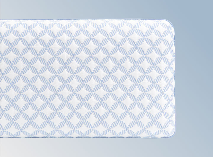 An image of the GlacioTex Cooling Pillow on a light blue gradient background