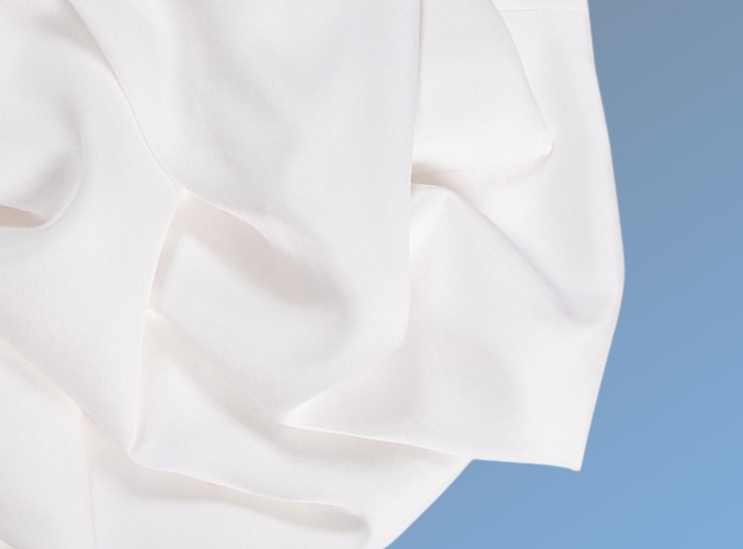 A closeup of the Cotton Blend Sheet Set on a blue background