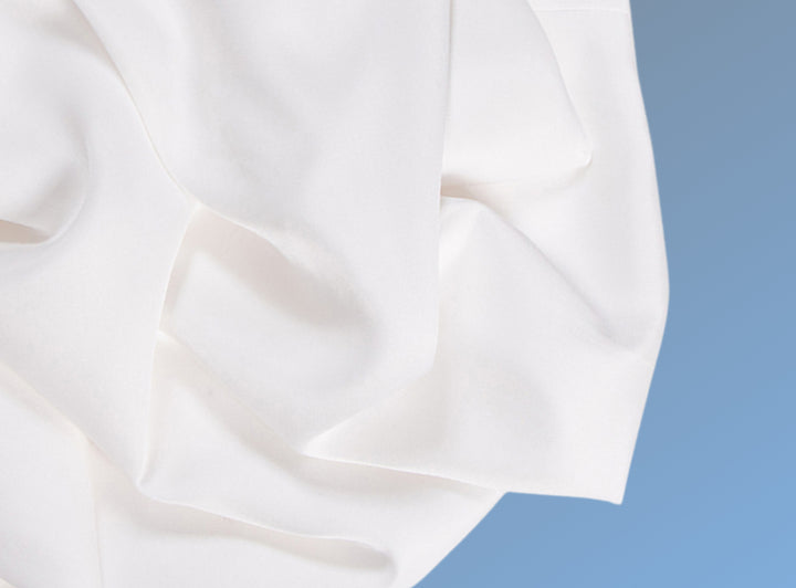 A closeup of the Cotton Blend Sheet Set on a blue background