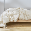 The Birch Duvet Insert laid across a Birch mattress in a bedroom scene