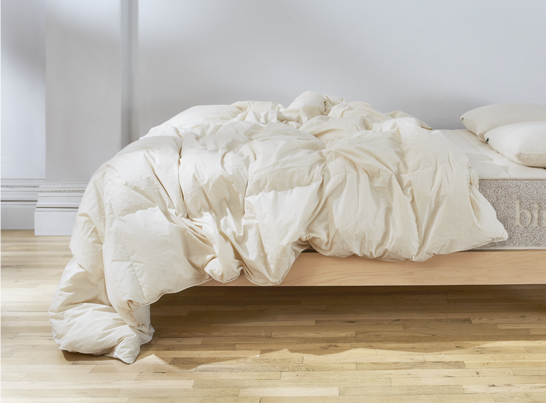 The Birch Duvet Insert laid across a Birch mattress in a bedroom scene