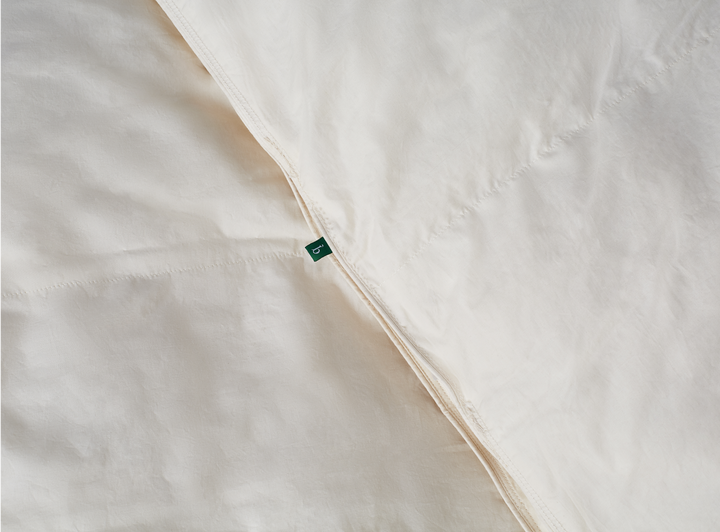A closeup of the Birch Duvet Insert showing the Birch logo tag