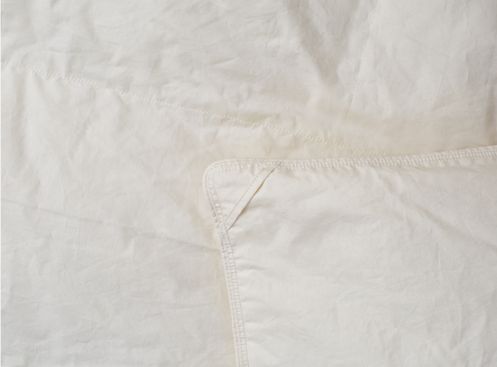 A closeup of the Birch Duvet Insert showing the sturdy stitching