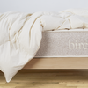The Birch Duvet Insert laid across a Birch mattress in a bedroom scene