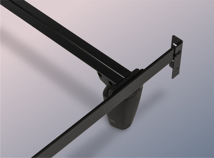 Close-up of a black metal bed frame on a gray background