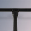 Close-up of a black metal bed frame on a gray background