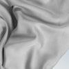 A closeup of the Tencel Sheet Set on a blue background