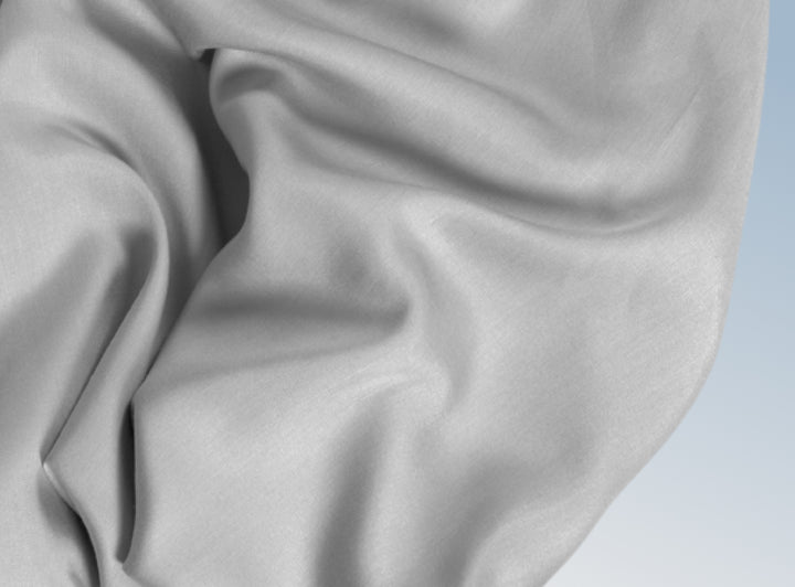 A closeup of the Tencel Sheet Set on a blue background