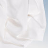 A closeup of the Tencel Sheet Set on a blue background