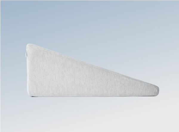 The Helix Wedge Pillow on a blue background