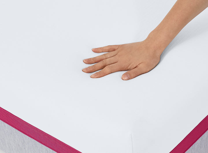 Hand pressing down on the medium feel Helix Dusk Mattress